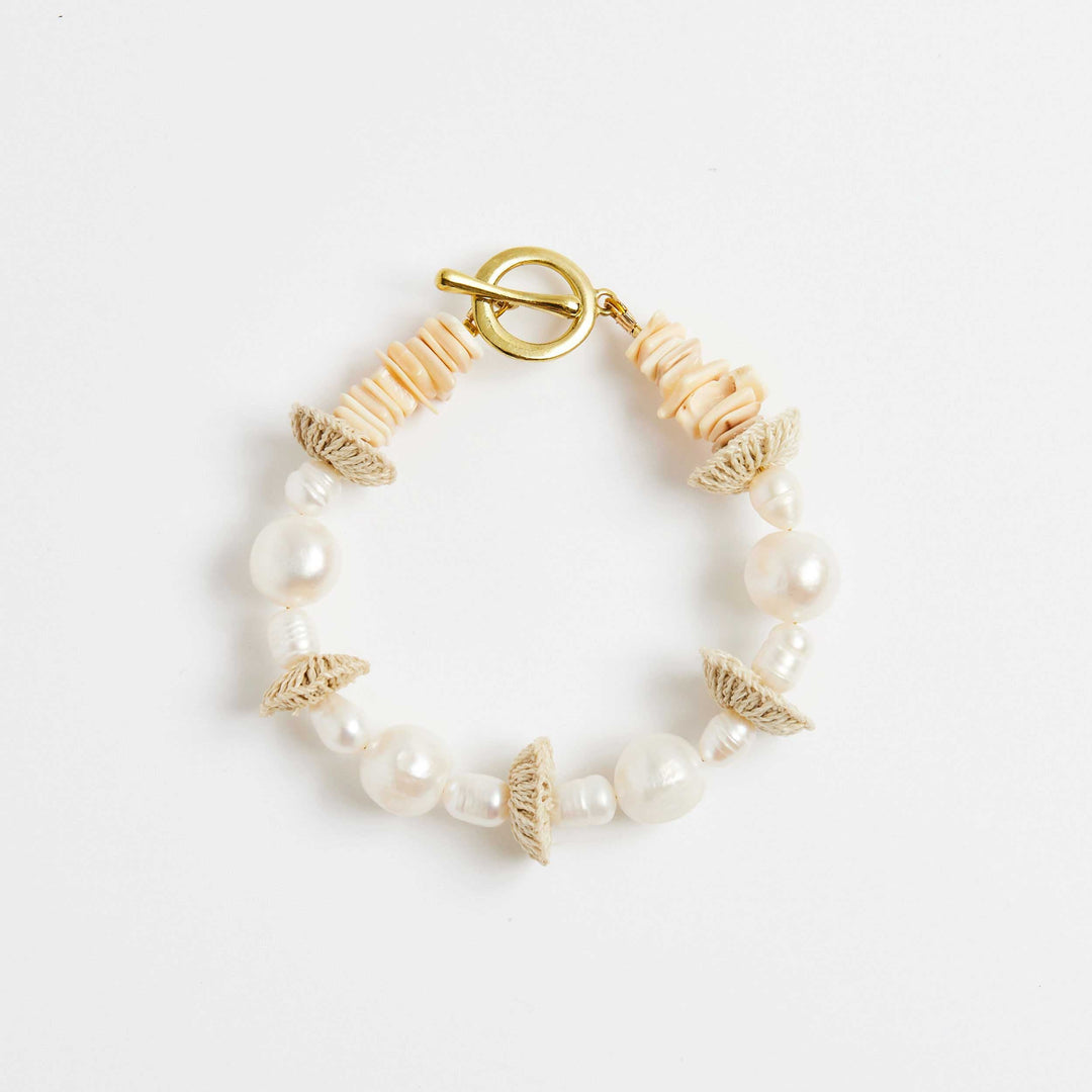 Front view of pearl stack bracelet with pearls and natural fibre woven discs