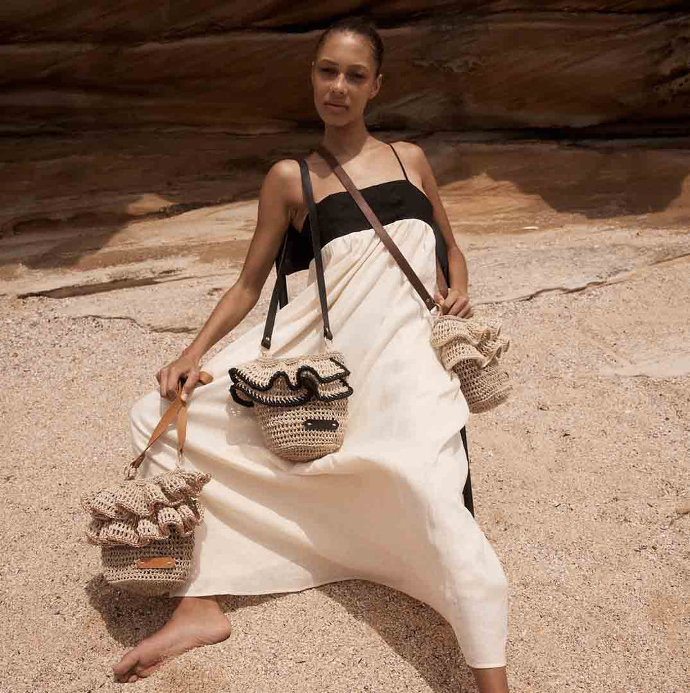 Ripple cross body bags on a model at beach.