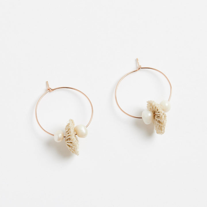 Small rose gold hoops with pearl and natural fibre discs side view