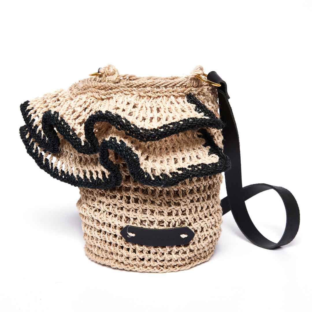 Side angle of the Ripple Cross Body Bag with woven ruffles with black trims.
