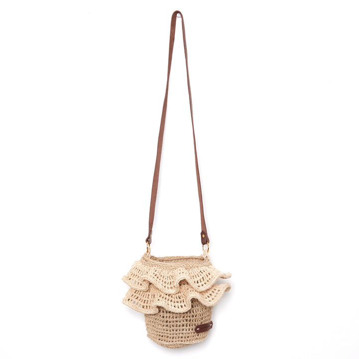 Woven basket bag with cross body leather strap and woven ruffle trims.