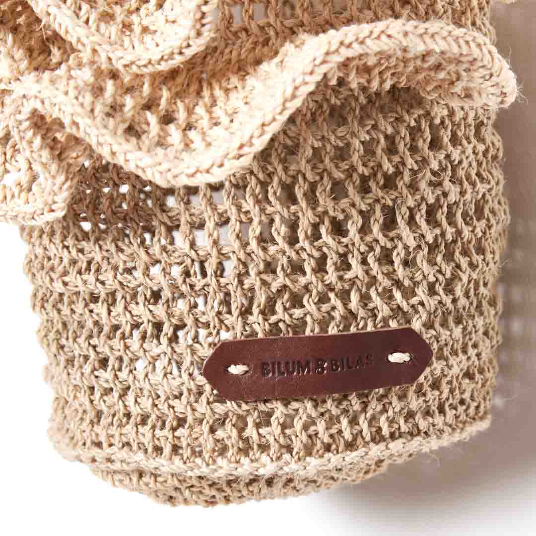 Detail shot of cross body ripple bag in natural.