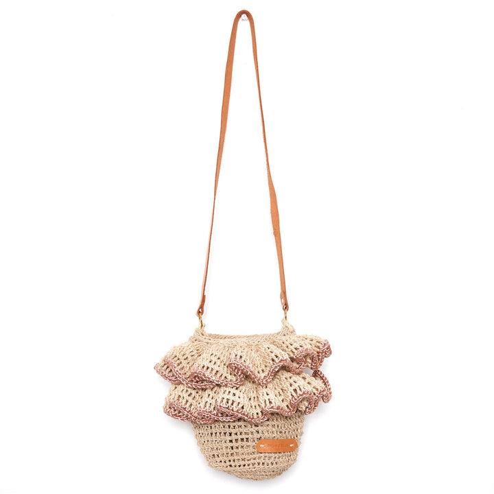 Ripple Cross body bag with woven ruffles with rose gold metallic trims and leather strap hanging on a white background.