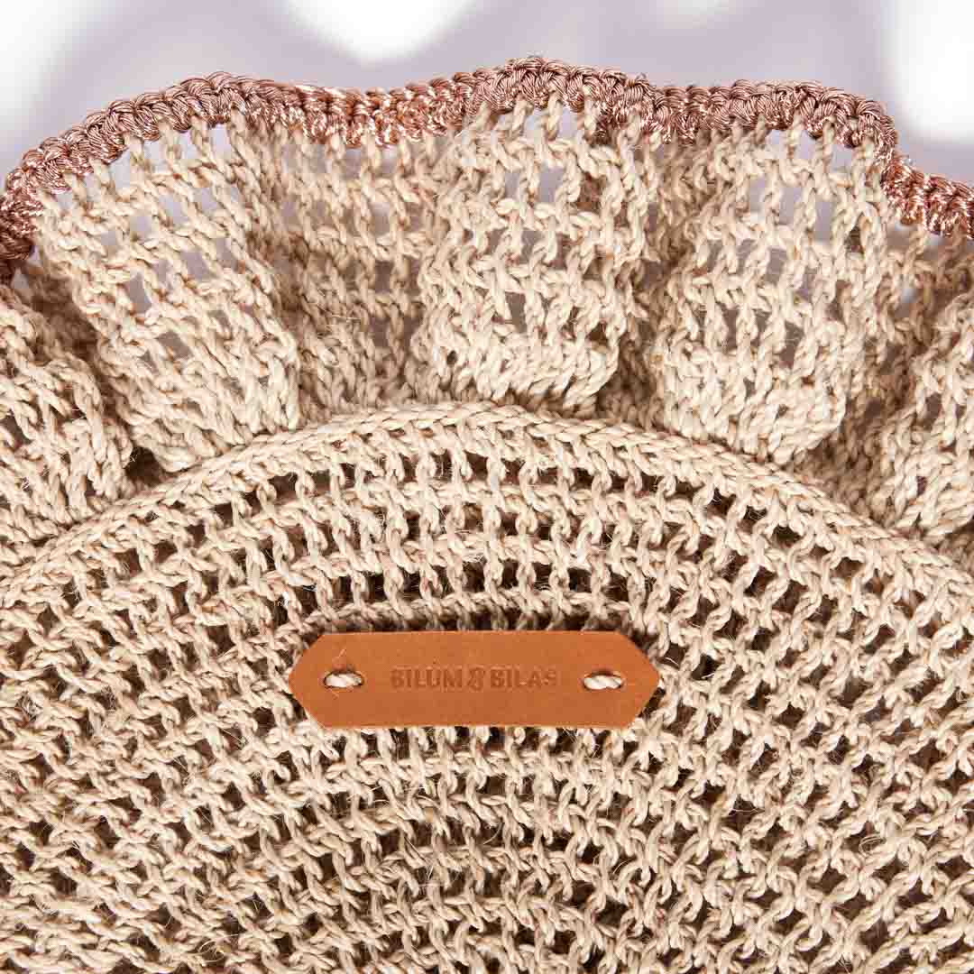 Detail close up of the handwoven ruffles with rose gold metallic trims of the Ripple clutch bag by Bilum and Bilas.