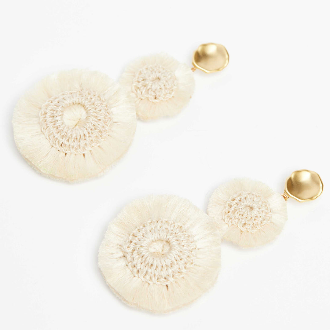 Side angle natural fibre pom pom earrings with gold