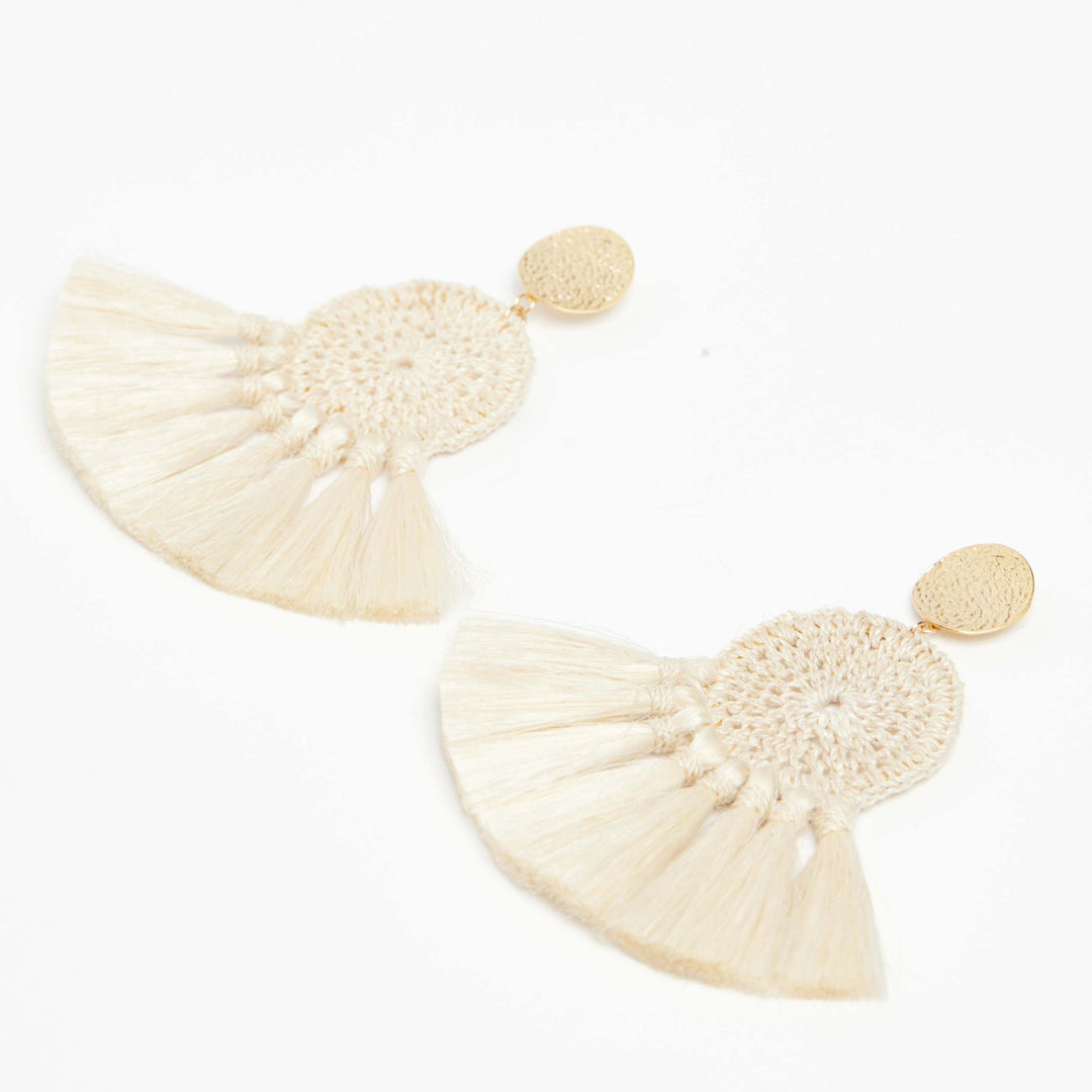 Woven disc earrings with fringing and gold disc on an angle.