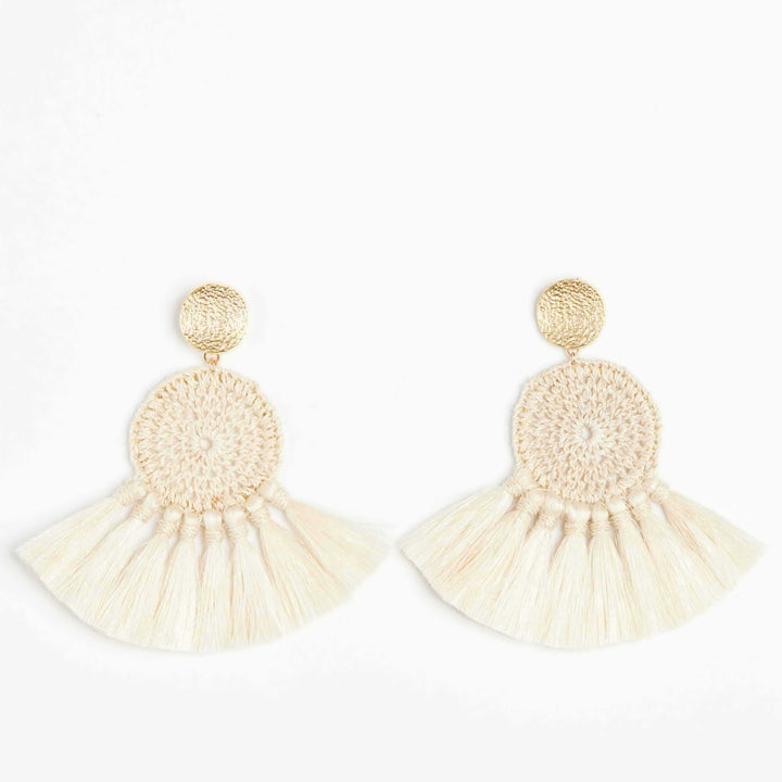 Woven disc earrings with fringing and gold disc on white background.