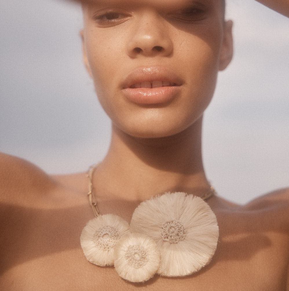 Statement bilum and bilas adjustable woven necklace on a model looking directly.
