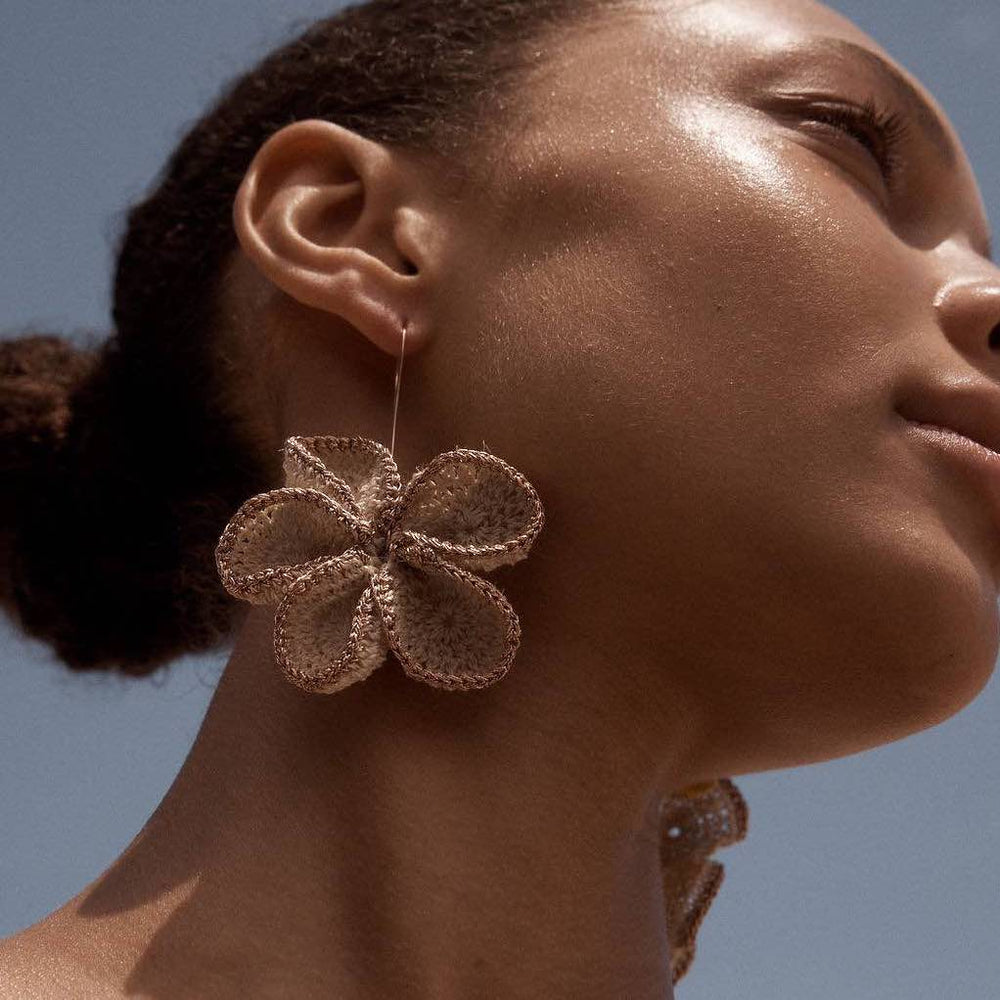 Model wearing bilum and bilas large woven flower earring with rose gold metallic trims #Rose Gold