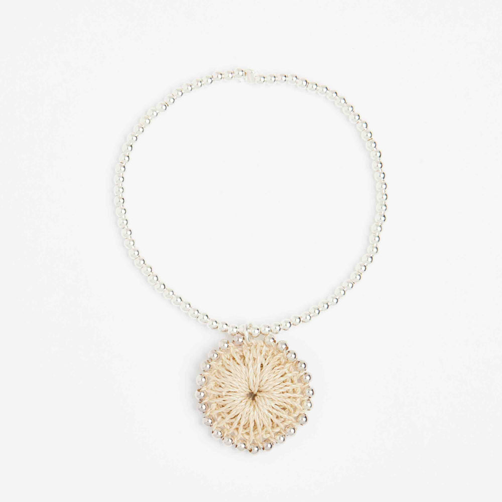 Silver beaded bracelet with natural fibre woven charm front view
