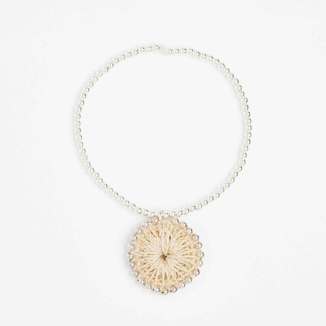 Silver beaded bracelet with natural fibre woven charm front view