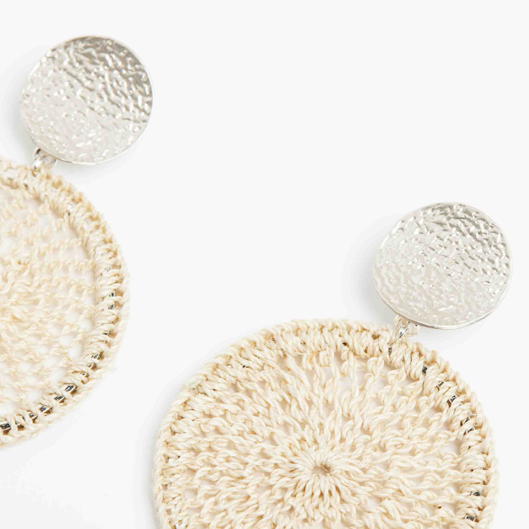 Close up Bilum and Bilas handwoven natural fibre and silver disc earrings