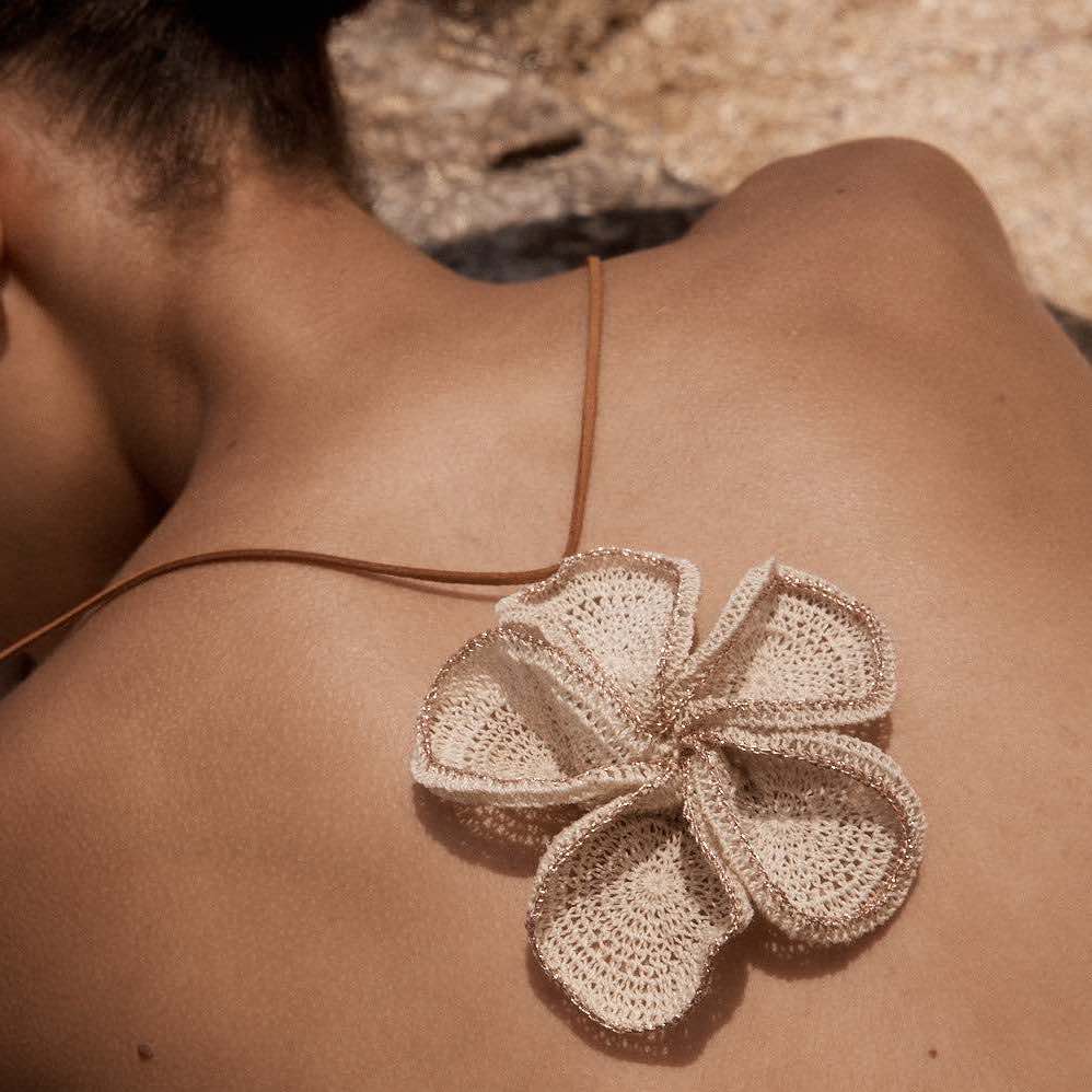 Flower pendant on models back.