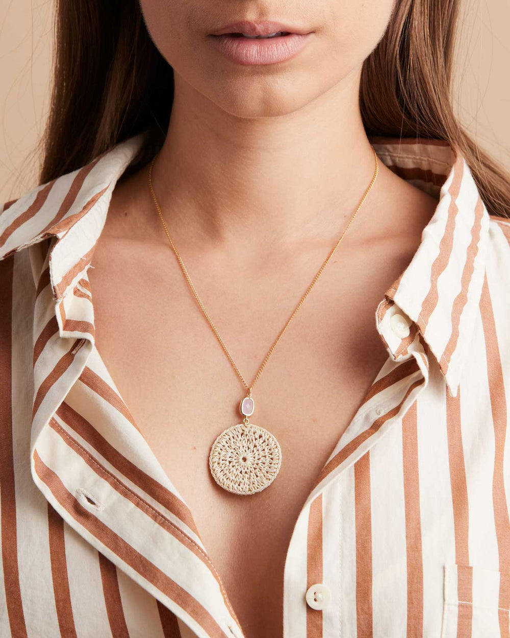 Model wearing Bilum and Bilas crochet style Kala necklace with pink stone pendant