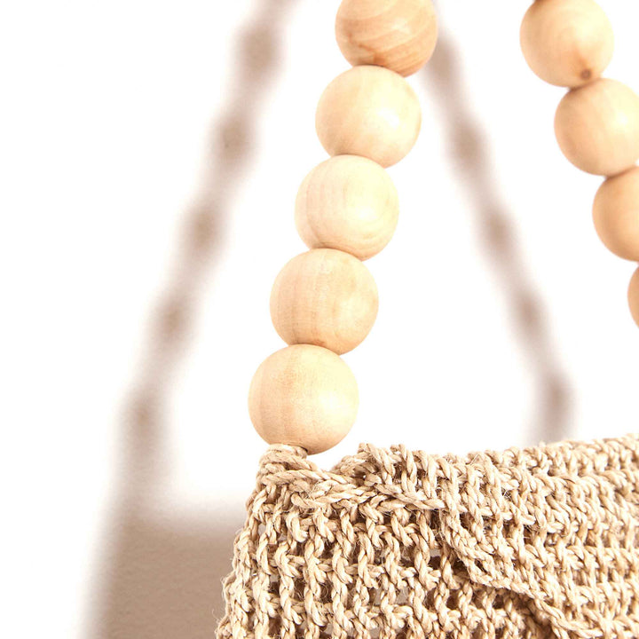 Beaded handle on woven bag