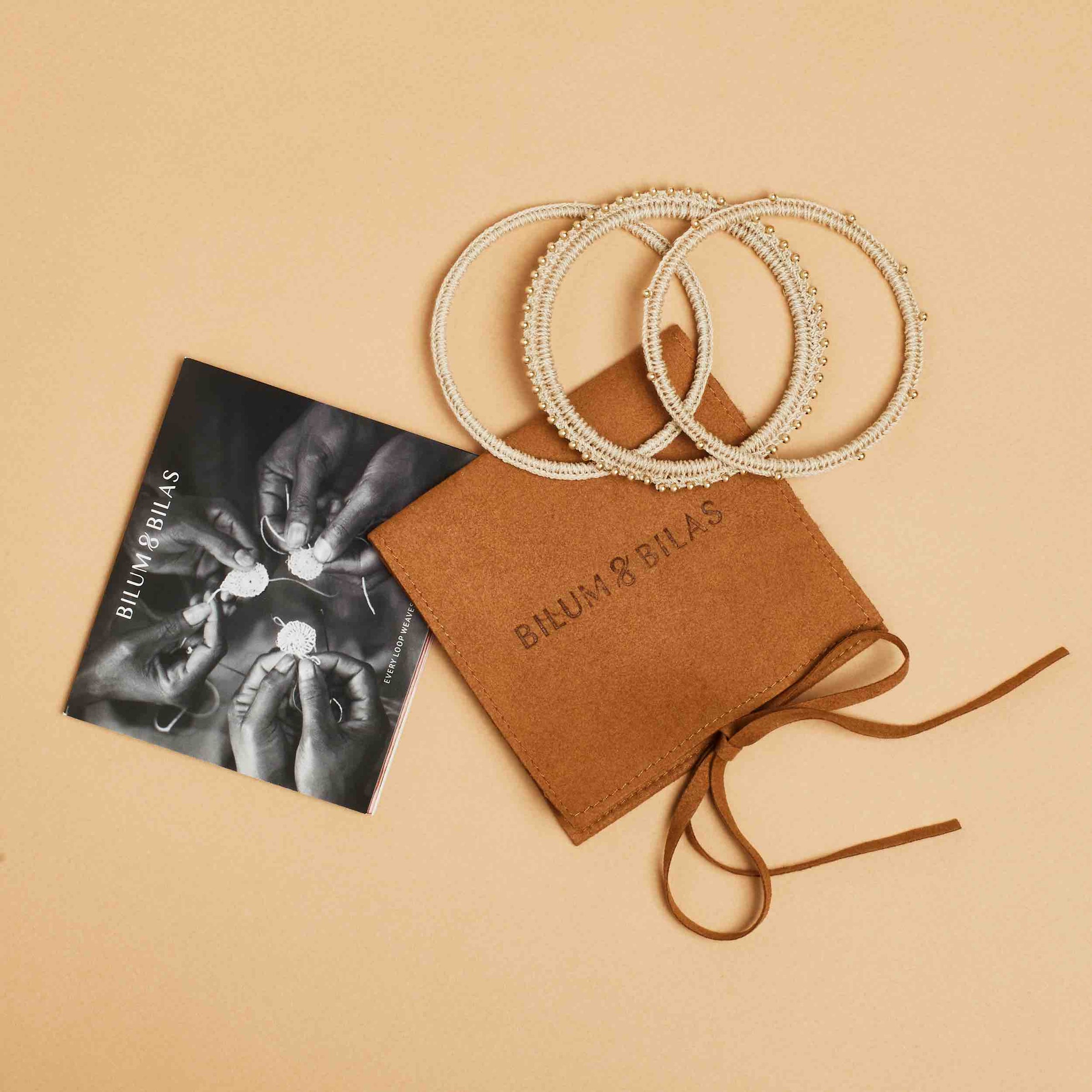 Bilum and Bilas jewellery packaging with handwoven bangle set with gold beading