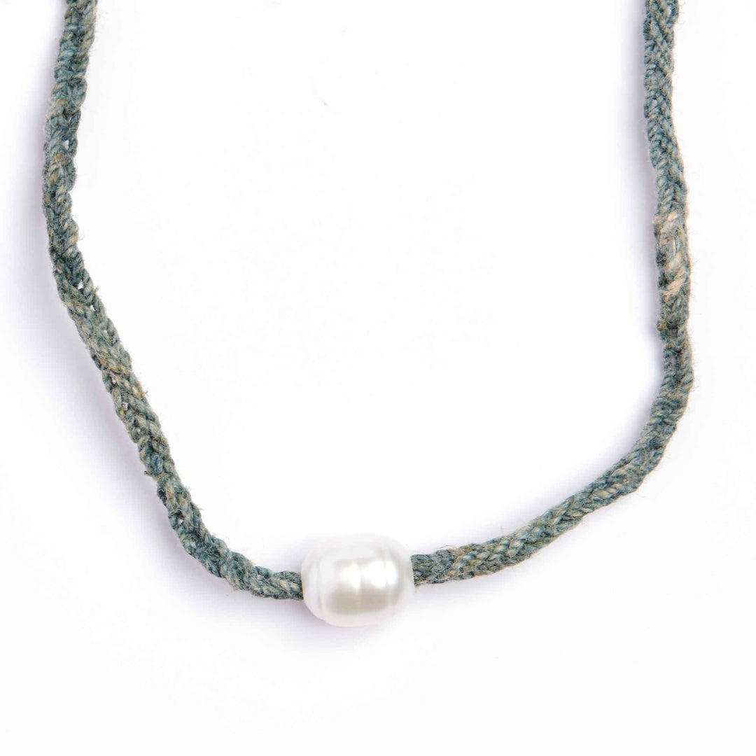Necklace with a single pearl on a white background