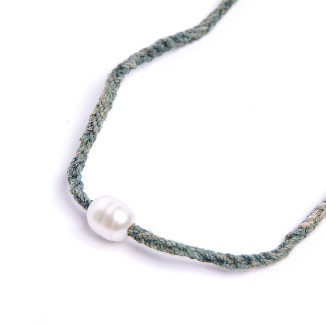 Necklace with a single pearl on a white background