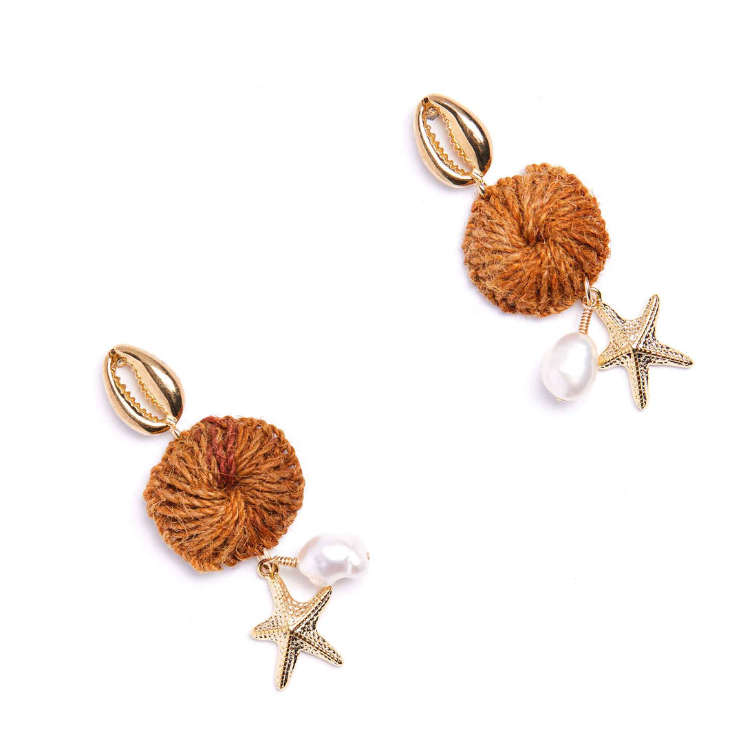 Pair of earrings with brown spherical charms, pearl beads, and starfish accents on a white background