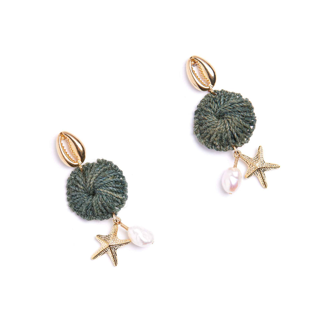 Pair of earrings with green pom-poms, starfish charms, and pearls on a white background