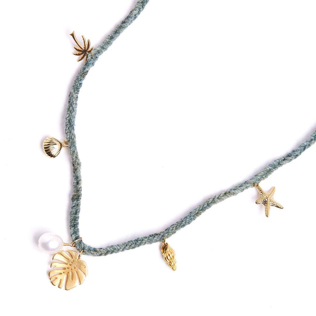 Necklace with gold charms including shells and a starfish on a white background