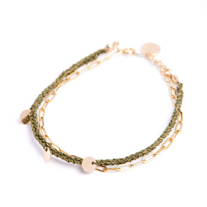 Green braided bracelet with gold chain on a white background