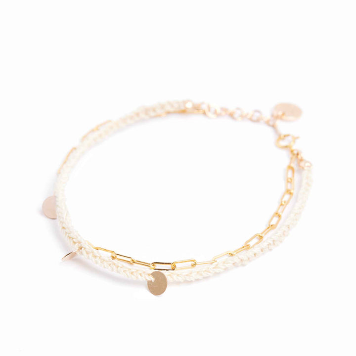 Gold and pearl bracelet on a white background