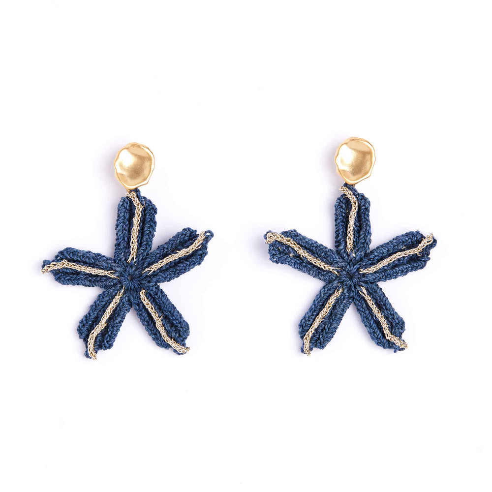 Pair of blue star-shaped earrings with gold accents on a white background