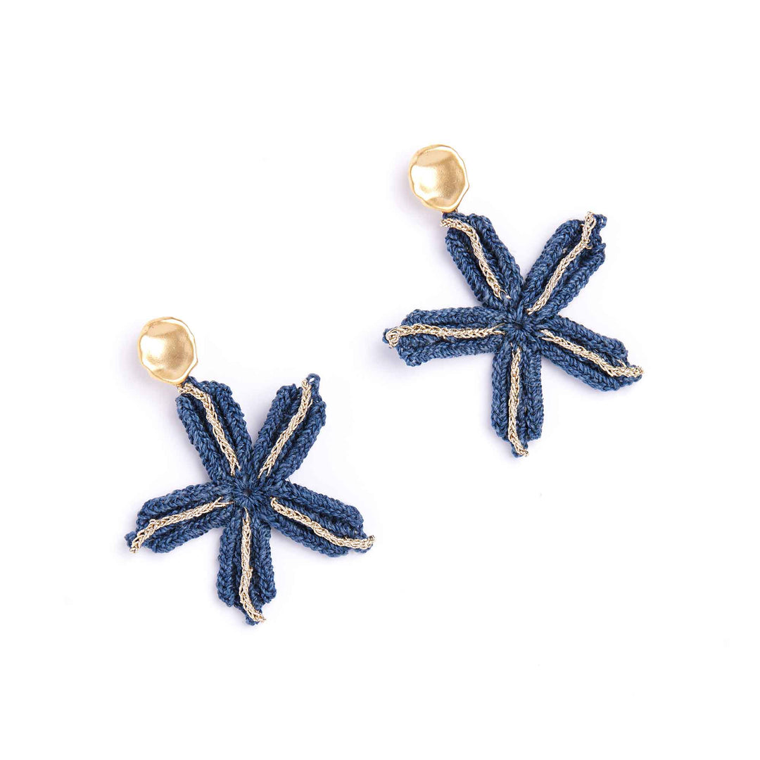 Pair of blue star-shaped earrings with gold accents on a white background