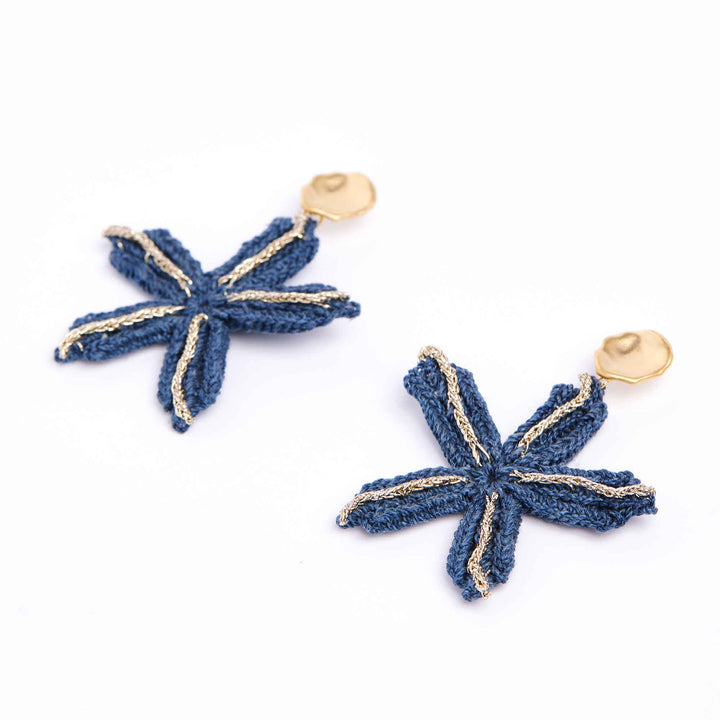 Blue star-shaped earrings with gold accents on a white background