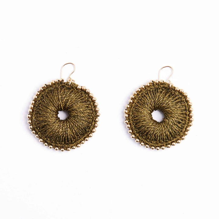Pair of gold circular earrings on a white background