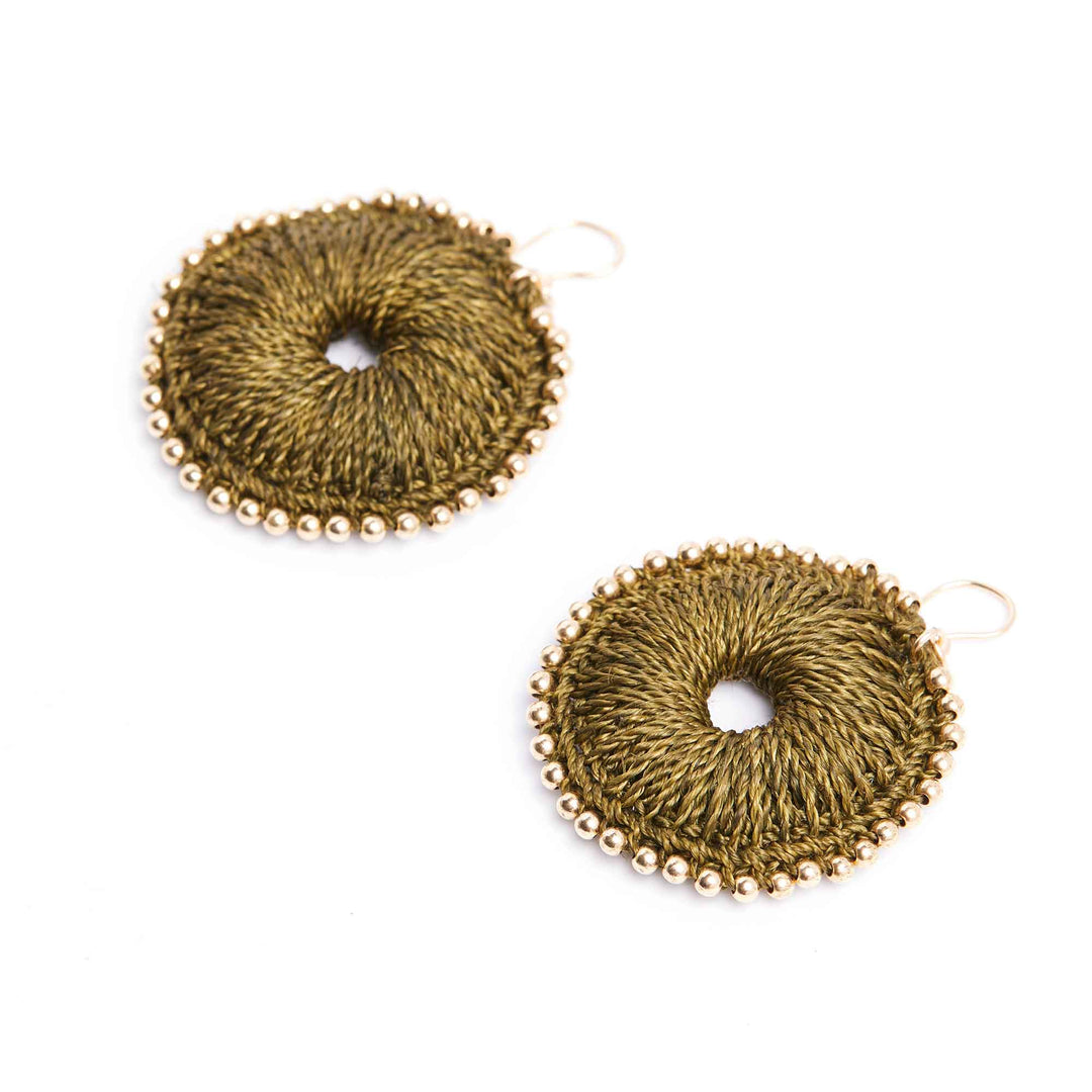 Pair of gold circular earrings on a white background