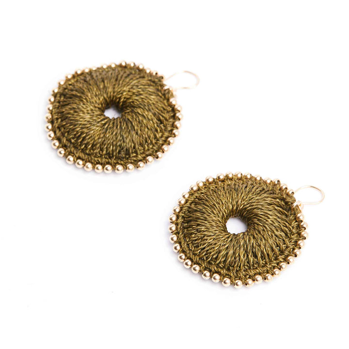 Pair of gold circular earrings on a white background