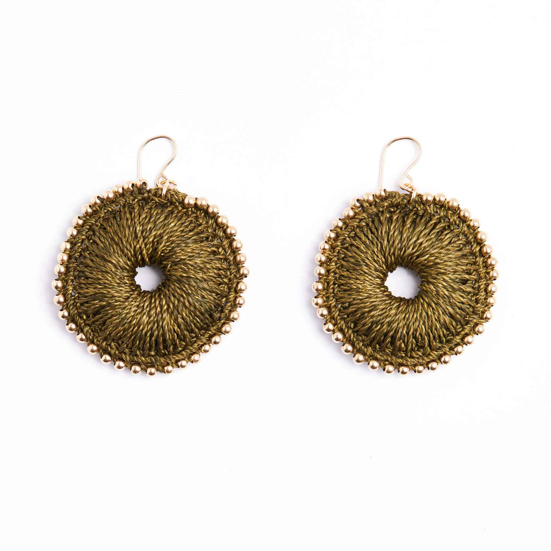 Pair of gold circular earrings on a white background