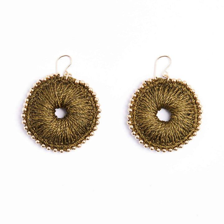 Pair of gold circular earrings on a white background