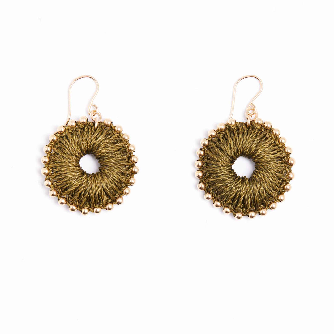 Gold circular earrings on a white background