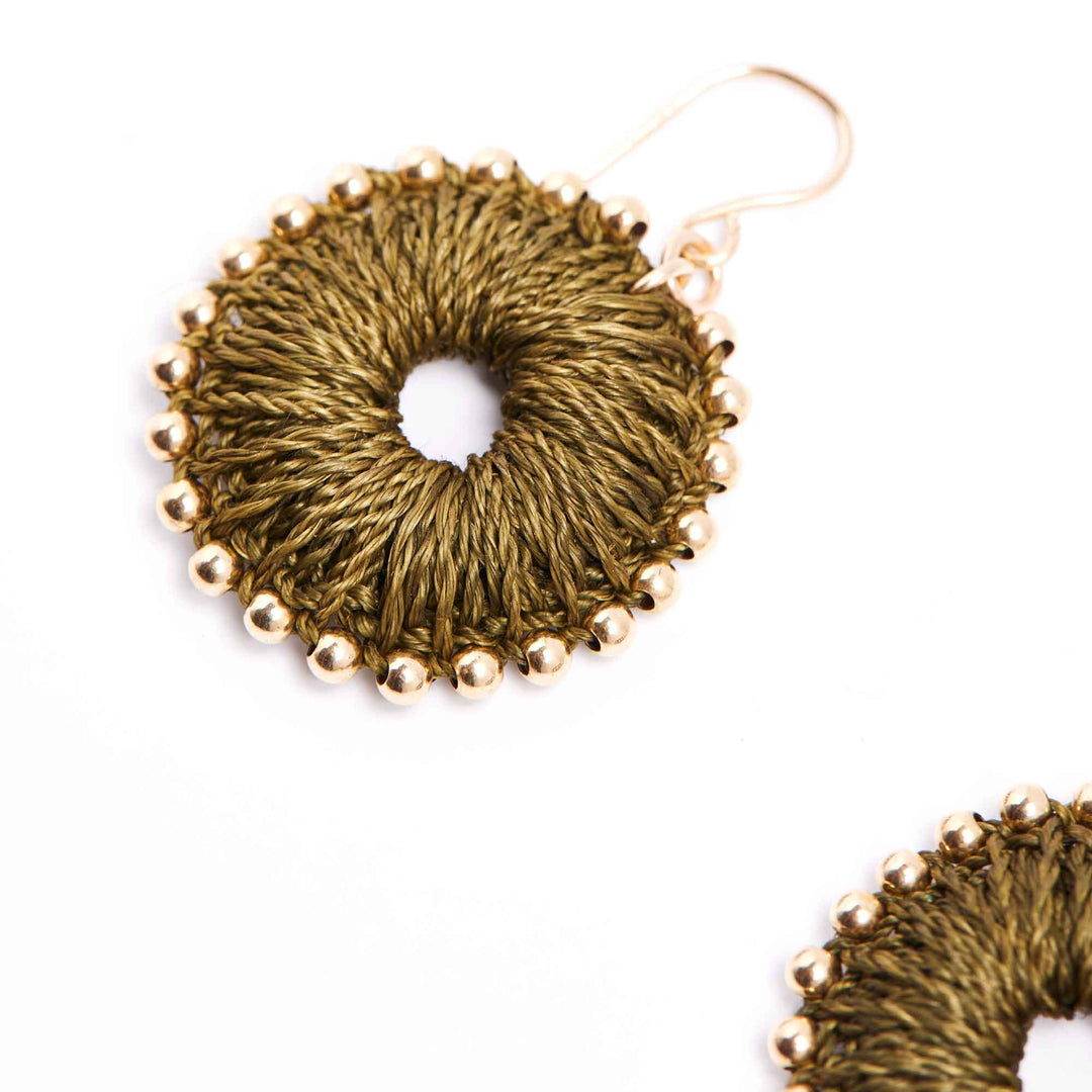 Gold circular earrings with bead detailing on a white background