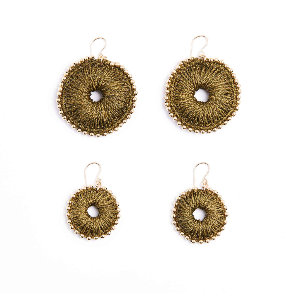 Set of four gold circular earrings on a white background