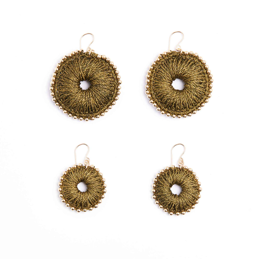 Set of four gold circular earrings on a white background