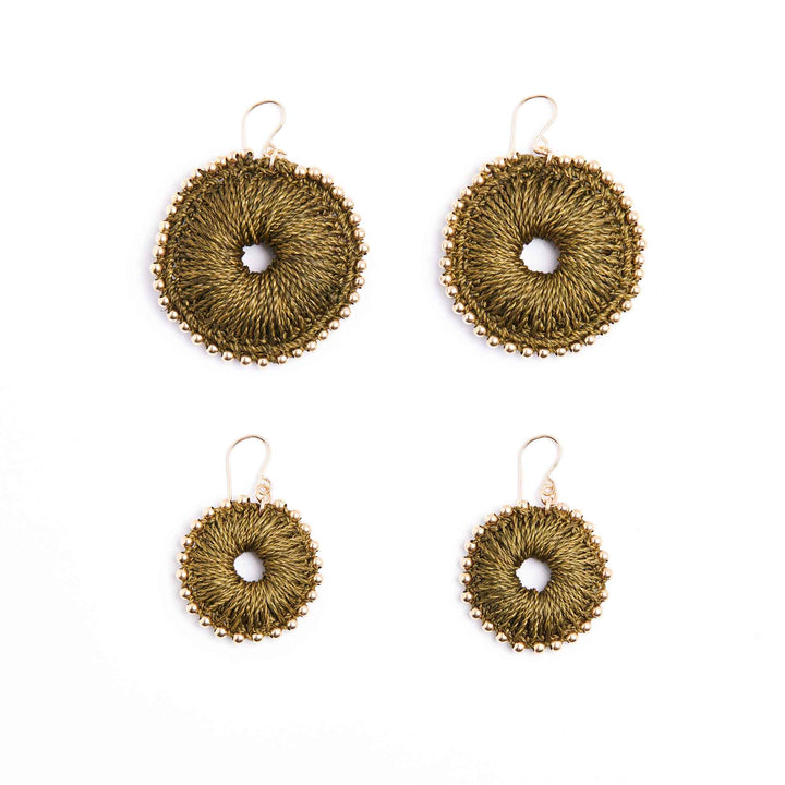 Set of four gold circular earrings on a white background