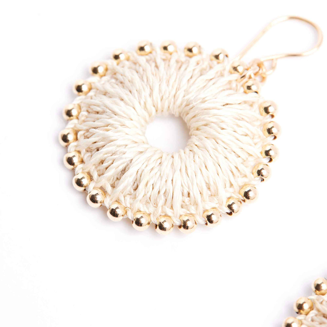 Gold beaded earrings on a white background
