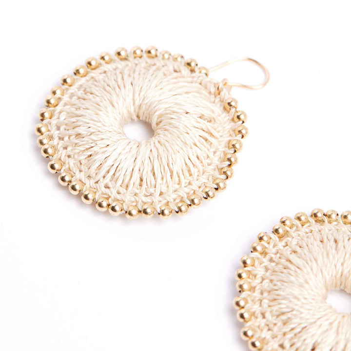 Pair of gold beaded earrings on a white background