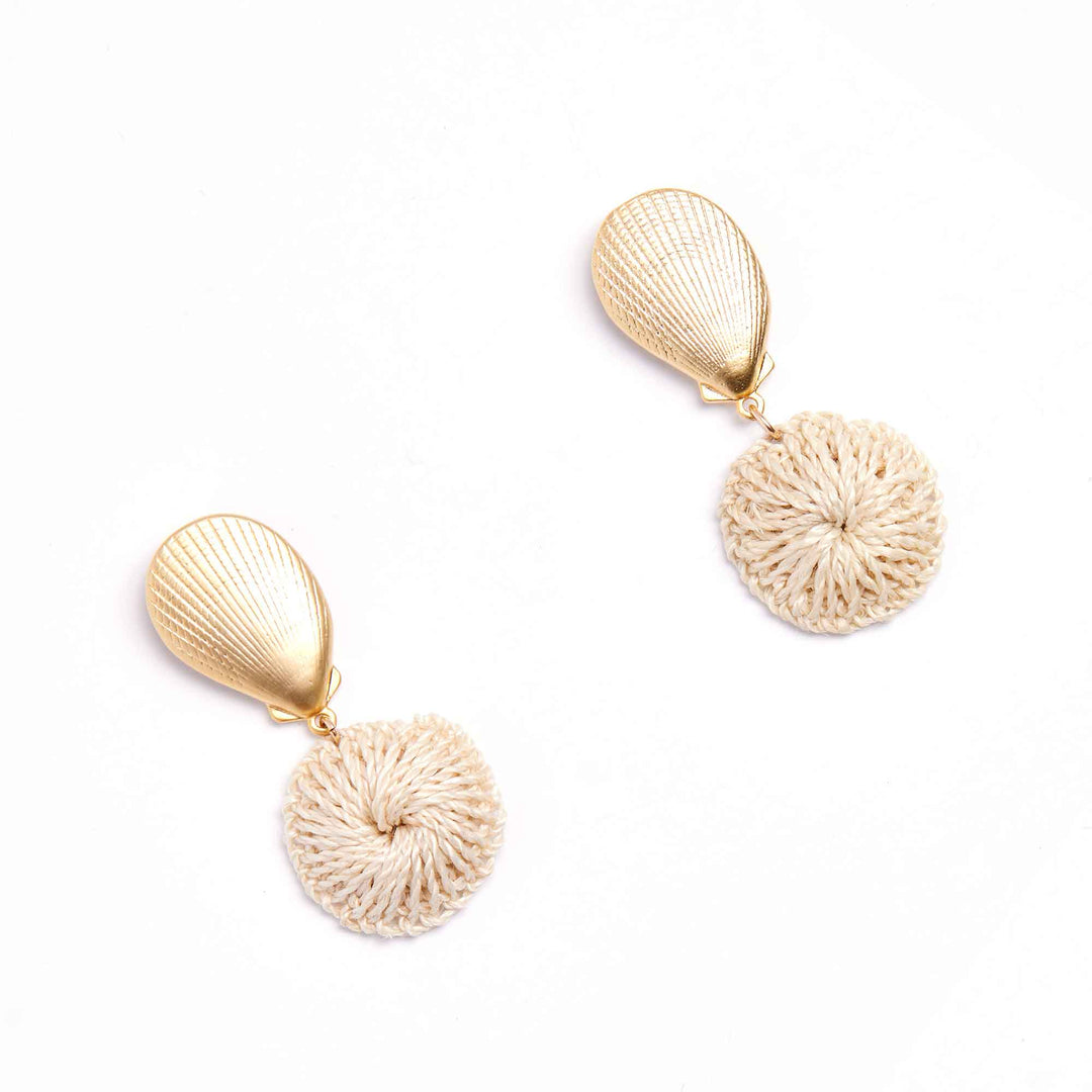 Pair of gold and beige earrings on a white background
