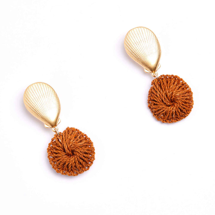 Pair of earrings with gold and rust-colored components on a white background