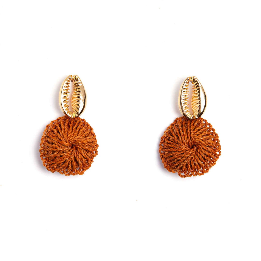 Pair of earrings with gold hooks and orange spherical pendants on a white background