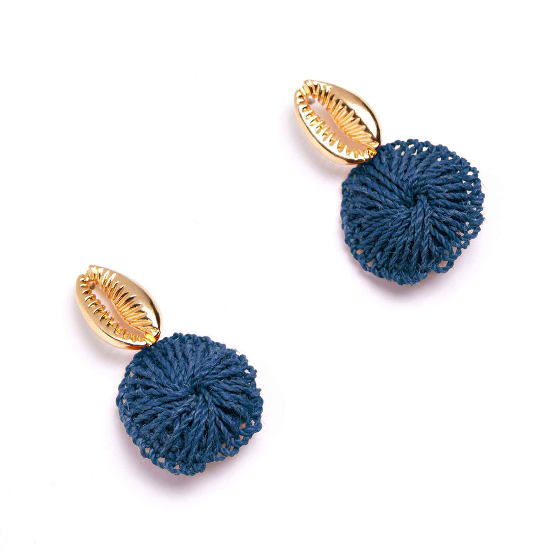 Pair of earrings with blue spherical charms and gold shell-like tops on a white background