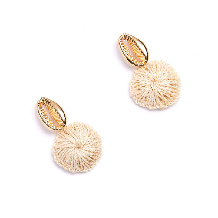 Pair of gold and beige earrings on a white background