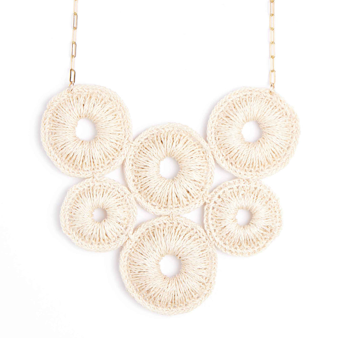Necklace with beige circular pendants on a white background