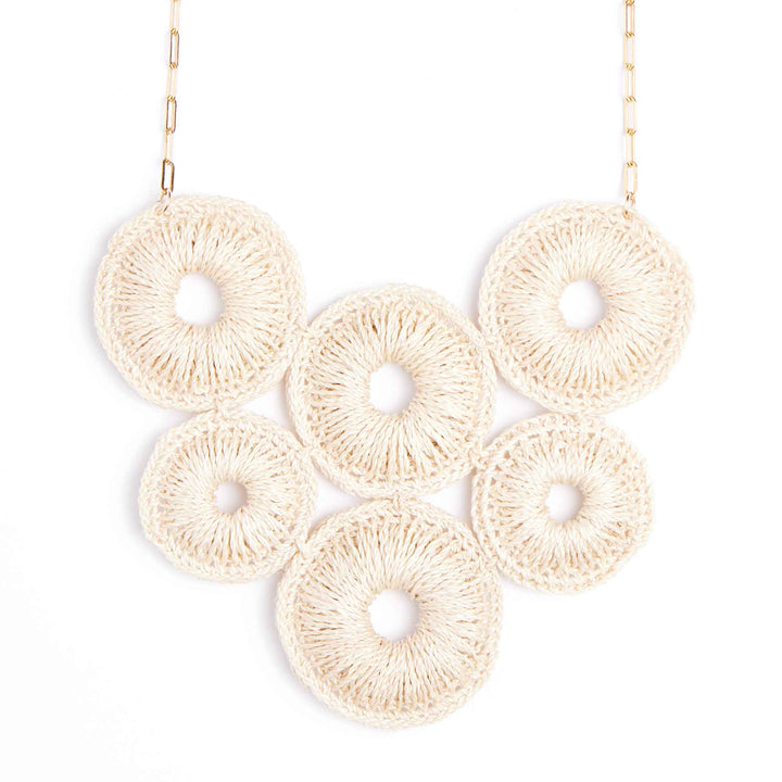 Necklace with beige circular pendants on a white background