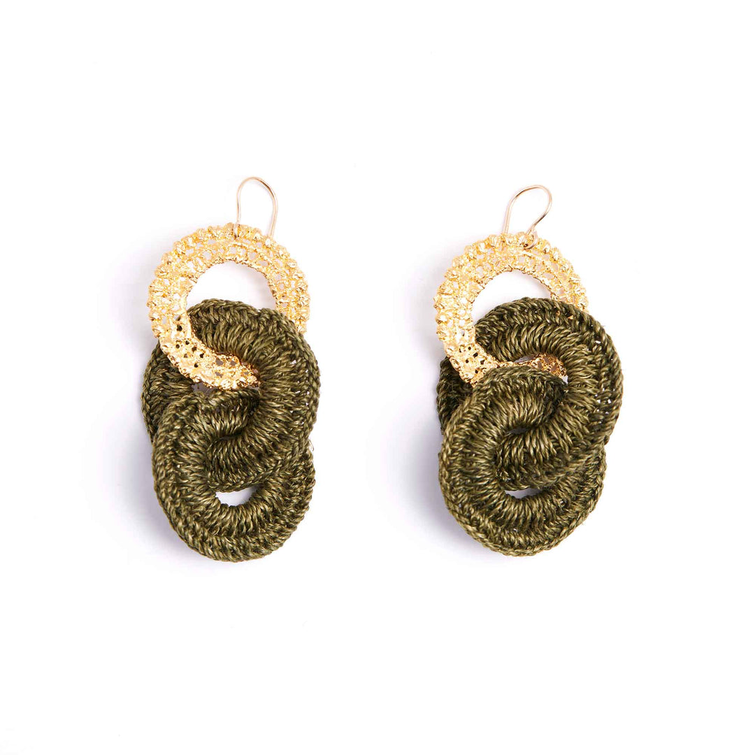Pair of green knotted earrings with gold circular accents on a white background